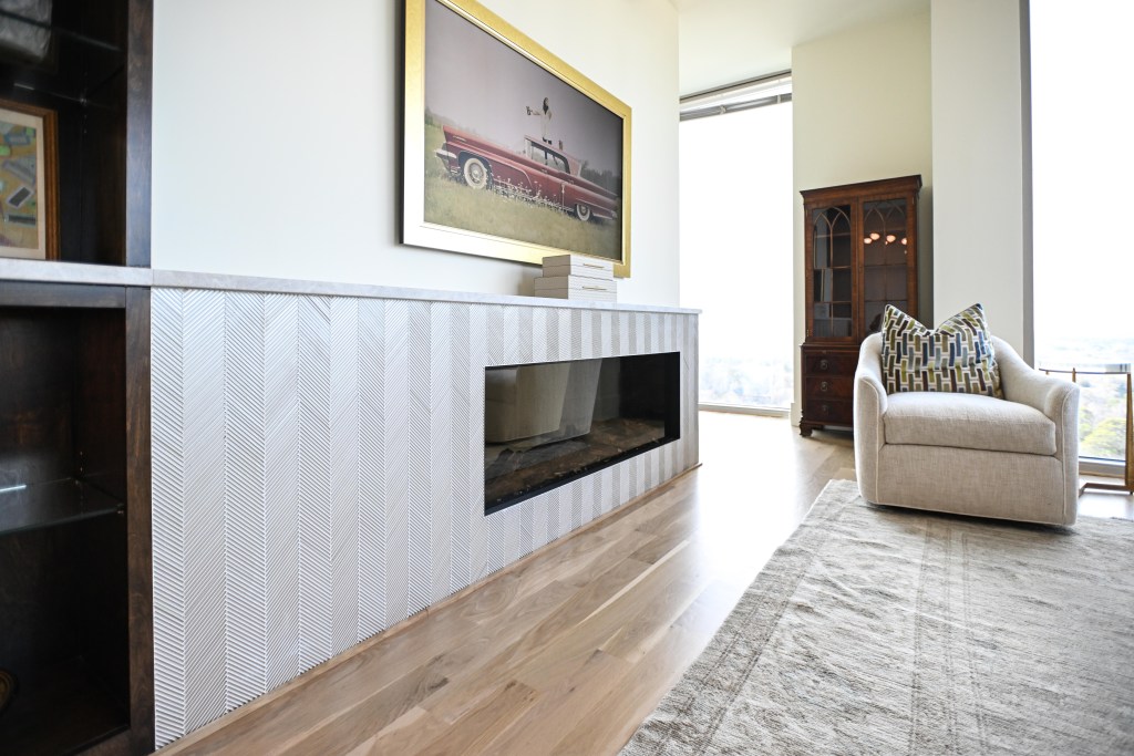 Custom square white oak shoe molding at the fireplace surround in a Buckhead high-rise condominium, fabricated and finished by Classy Flooring ATL in the same white oak and LOBA 2K Duo satin as the 4-inch solid white oak floor.