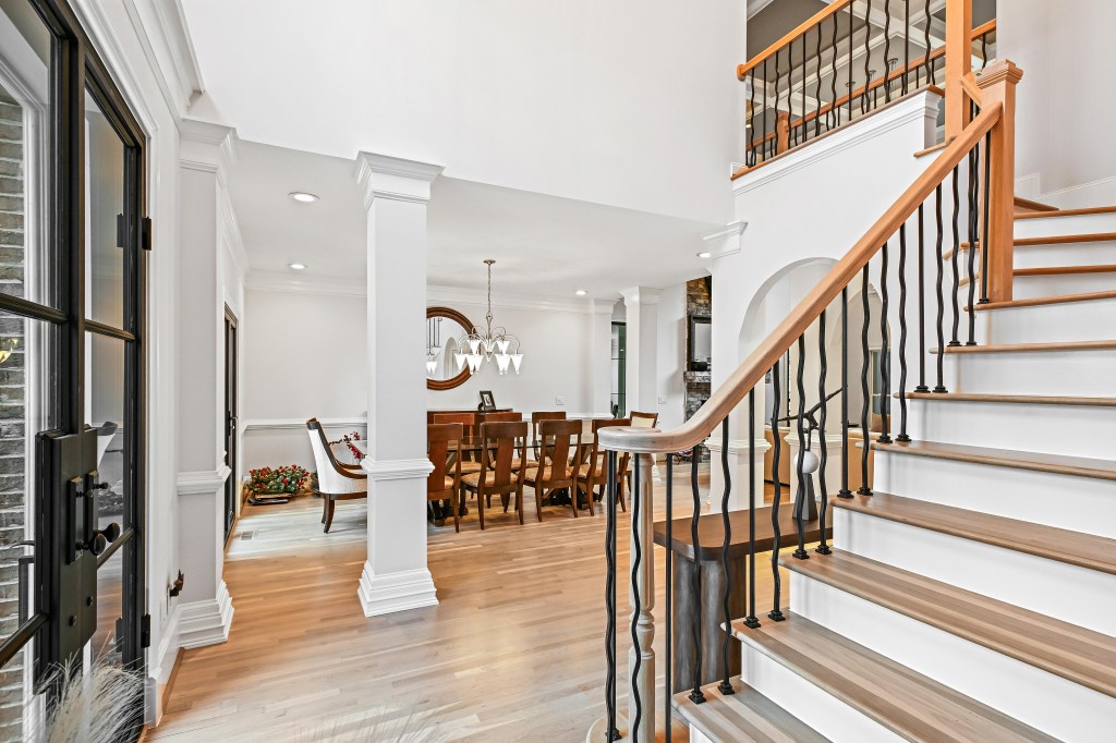 Refinished white oak floor and staircase near the foyer — NordicSeal neutral, Hoschton GA near Château Élan