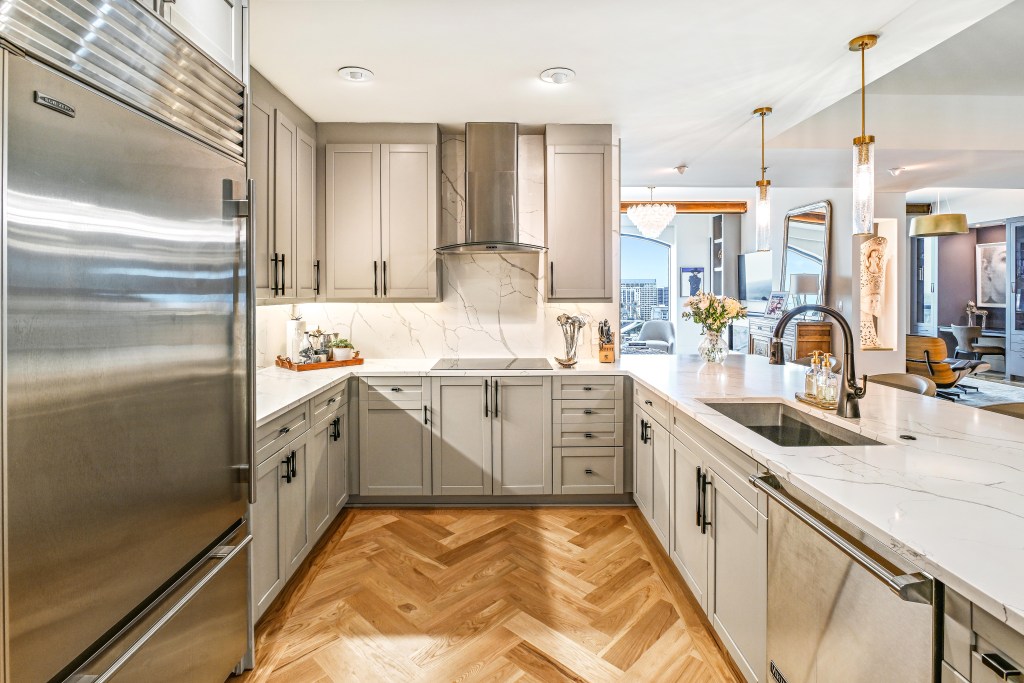Finished white oak herringbone floor running through the kitchen of a Buckhead high-rise, Atlanta.