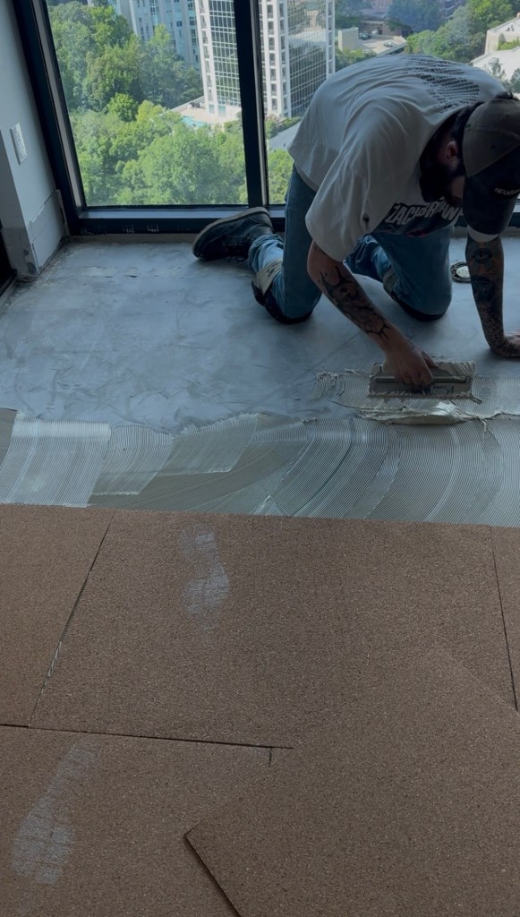 Crew setting Roberts Natural Cork panels with Wakol MS 260 adhesive on prepared concrete subfloor, Buckhead Atlanta