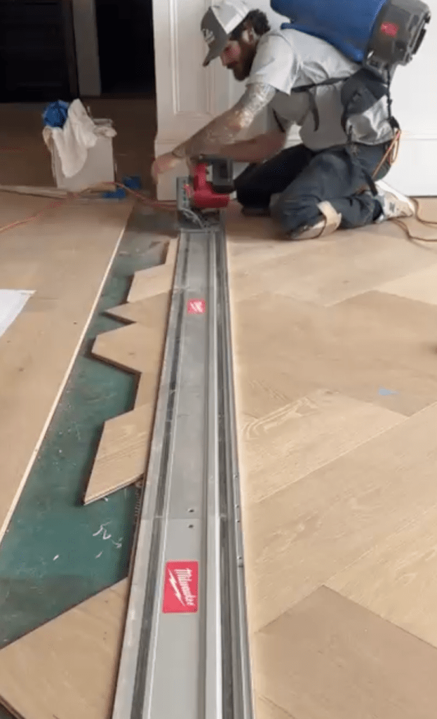 Cutting border pieces for custom herringbone installation with prefinished engineered oak flooring in Atlanta