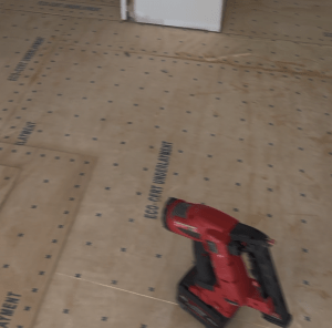 Plywood subfloor fastened with a high-density screw pattern during hardwood installation preparation by Classy Flooring ATL in Atlanta