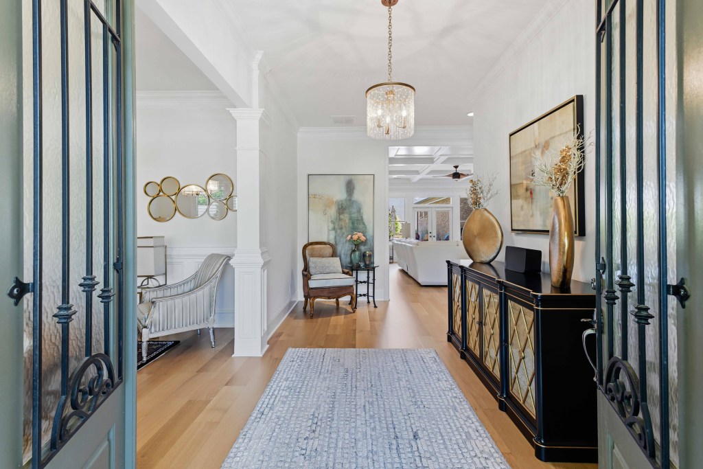 Rift and quartersawn white oak, site-finished with Bona Traffic HD, installed by Classy Flooring ATL in a Chateau Elan residence, Braselton GA — foyer and entry hall view looking into the main living area.