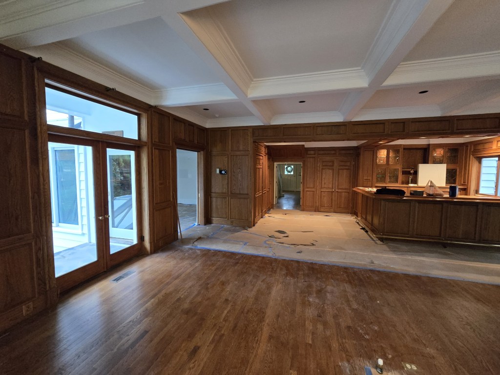 Original white oak floor before refinishing, warm amber tone with satin sheen, Buckhead residence.