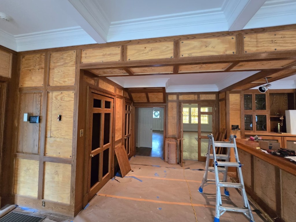 Oak paneling framing exposed after panel removal for off-wall refinishing — Classy Flooring ATL, Buckhead