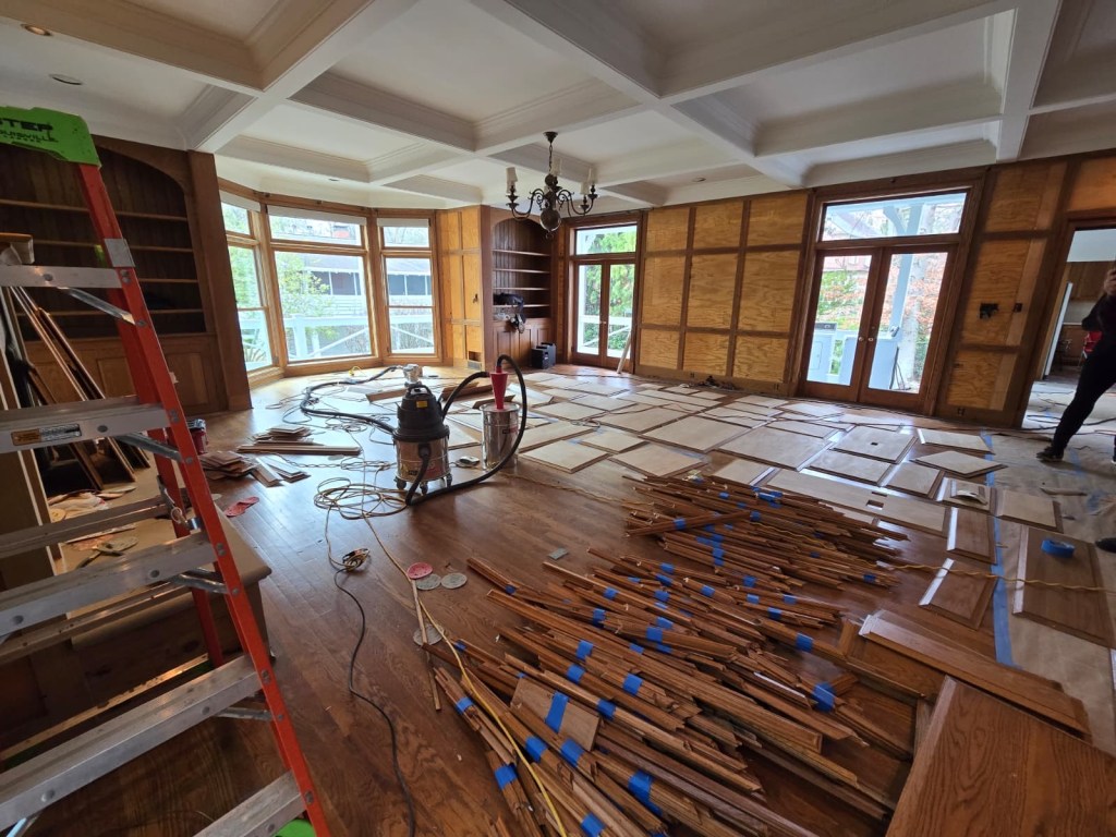 Removed oak panels and trim pieces staged and numbered for off-wall refinishing — Classy Flooring ATL, Buckhead
