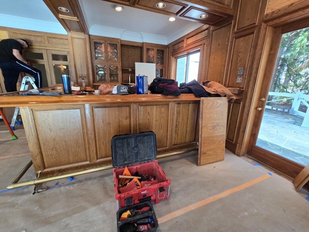 Traditional oak raised-panel millwork — Buckhead great room before Rubio Monocoat Linen refinish