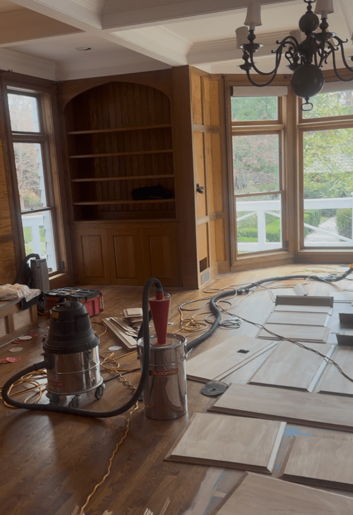 In-place sanding of oak paneling framing with HEPA-vacuum-connected palm sander — Classy Flooring ATL, Buckhead