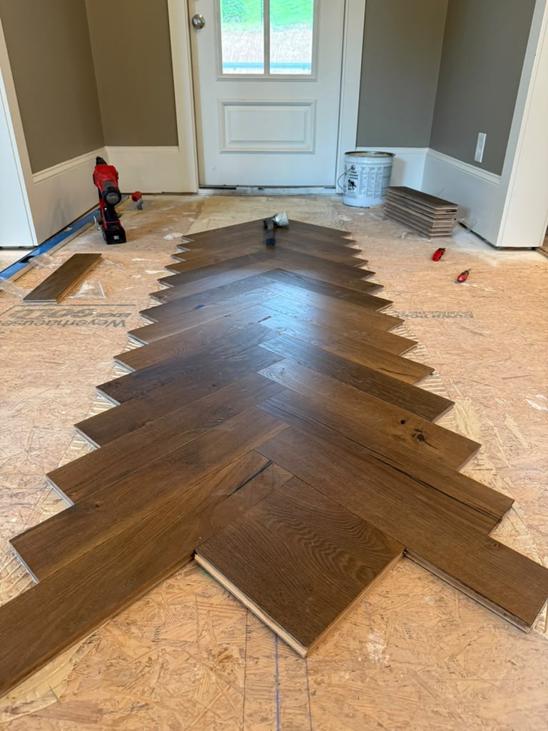 Fabricated engineered herringbone being set out from the centerline on a plywood subfloor in a Dunwoody, GA entrance
