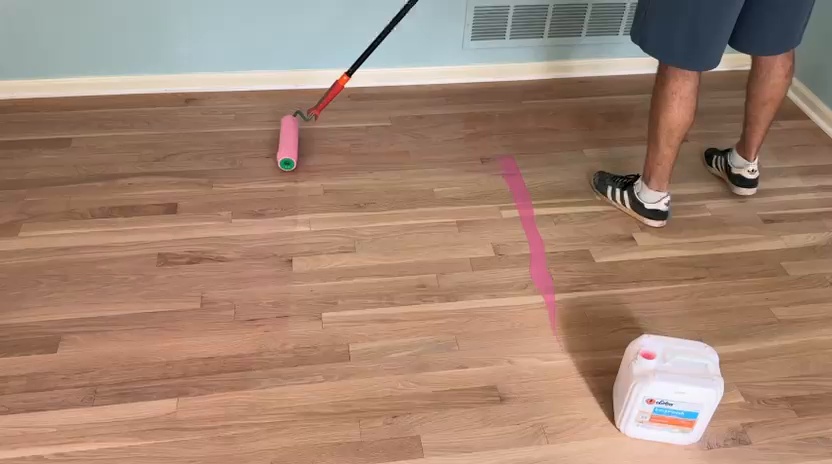 Rolling the tinted LOBA 2K Duo coat onto a white oak floor in Dunwoody GA