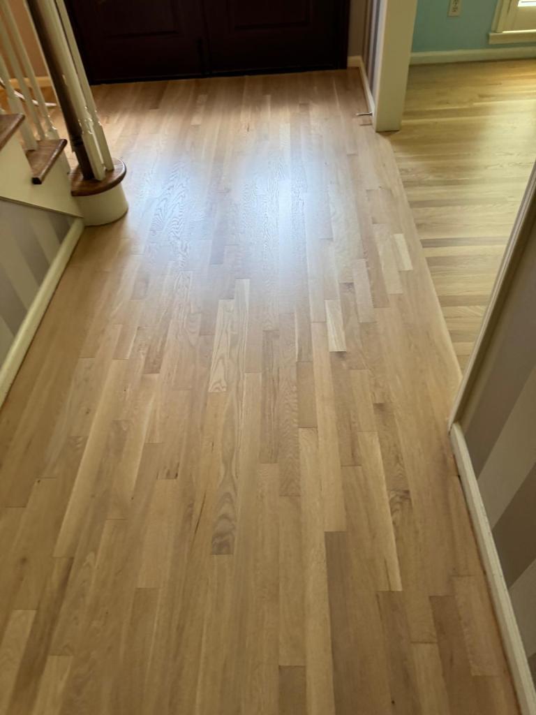 Refinished white oak meeting the existing red oak at the living area opening, Dunwoody GA
