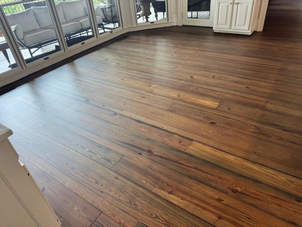 Reclaimed heart pine flooring finished in DuraSeal Jacobean with satin AquaSeal CeramicStar, wide boards running toward the window wall, Big Canoe, Georgia