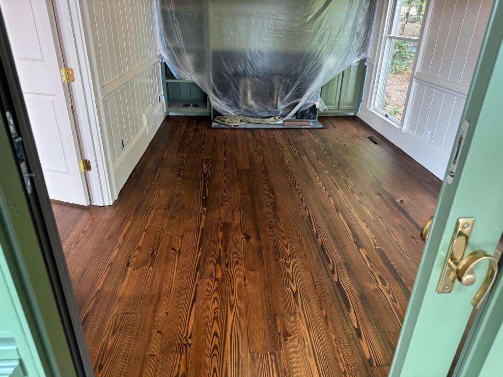 Southern yellow pine flooring finished in DuraSeal Espresso with new white primed quarter round at the base of the beadboard walls, Big Canoe, Georgia