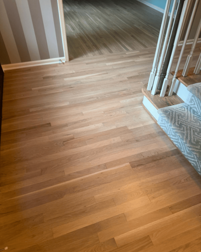 Transition between the refinished white oak floor and the existing red oak floor at the living area opening, Dunwoody GA