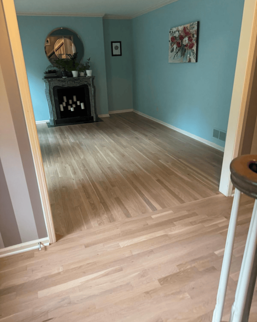 Transition from the refinished white oak floor to the existing living room floor at the doorway, Dunwoody GA