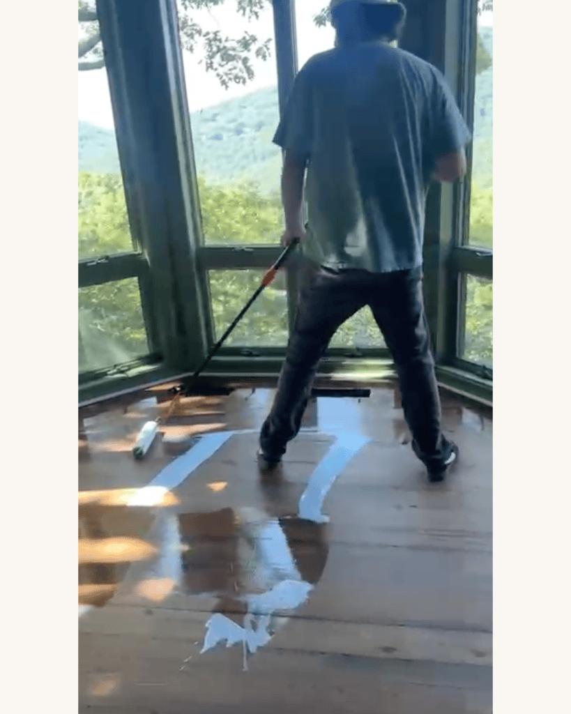 Applying the final coat of Berger-Seidle AquaSeal CeramicStar satin finish to a restored reclaimed heart pine floor in Big Canoe, Georgia