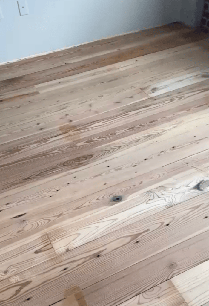 Heart pine floor sanded to bare wood during refinishing, grain and knots open with no finish remaining, Roswell, Georgia