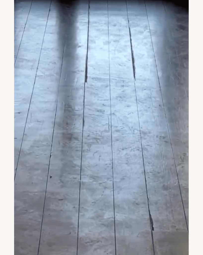 Reclaimed heart pine flooring with open board gaps and worn oil-based polyurethane before refinishing, Big Canoe, Georgia